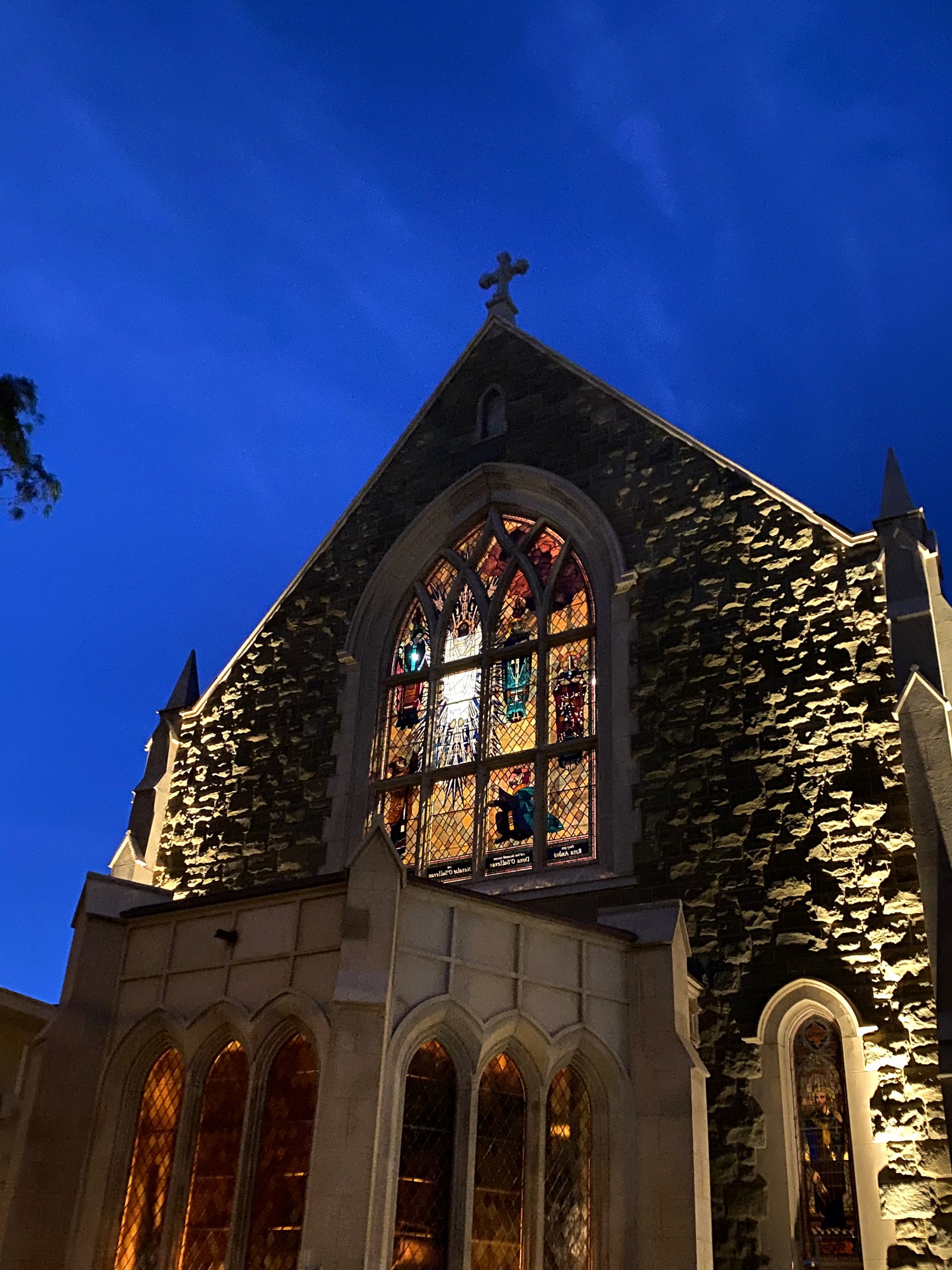 St Peters Church stained glass windows lit from inside, view from Toorak Road