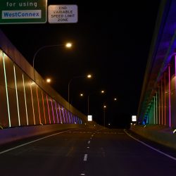 Side walls of WestConnex link are lit up rainbow thanks to wattle dives programmed with smart lighting control on a pharos system