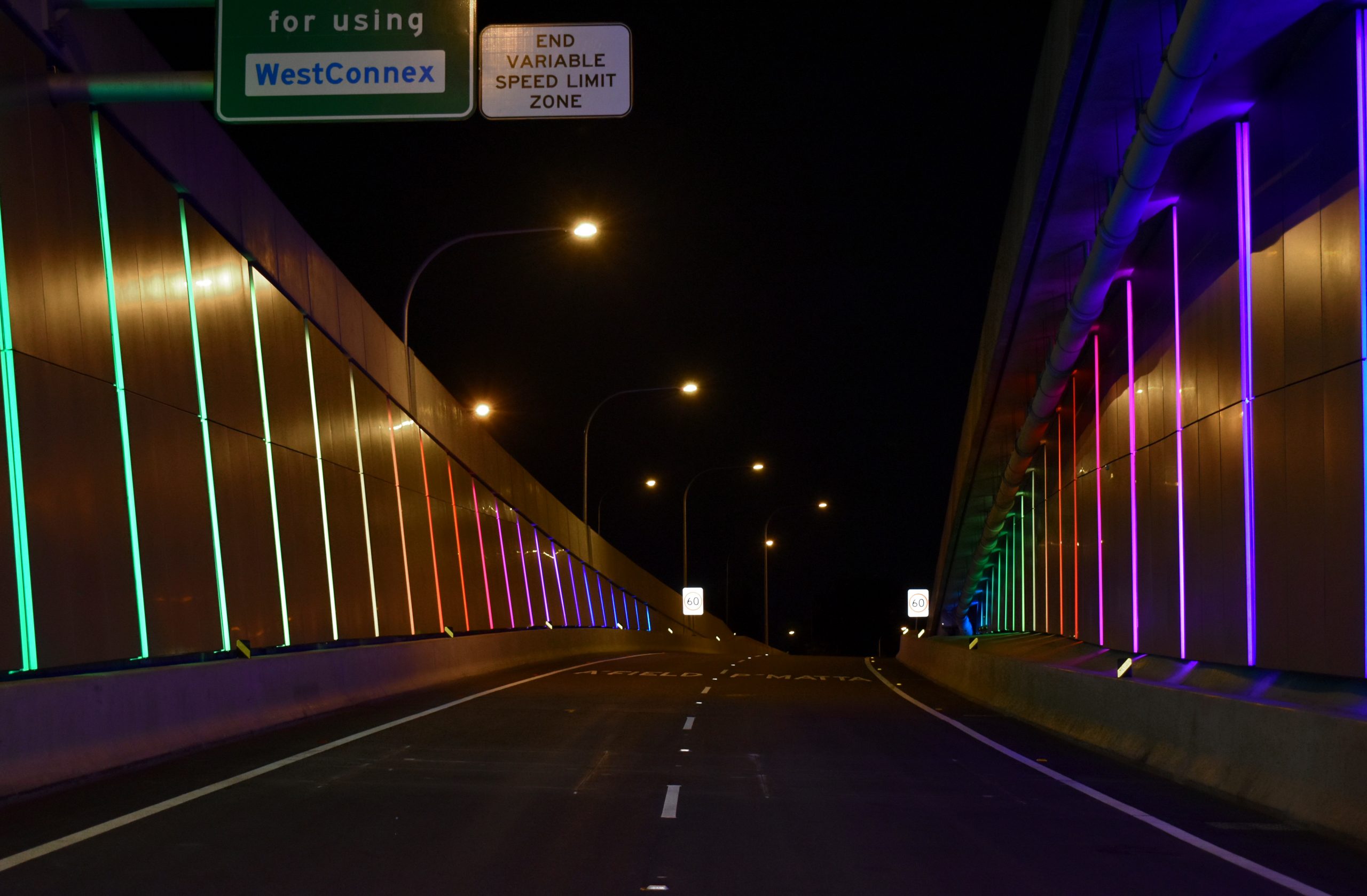 Side walls of WestConnex link are lit up rainbow thanks to wattle dives programmed with smart lighting control on a pharos system